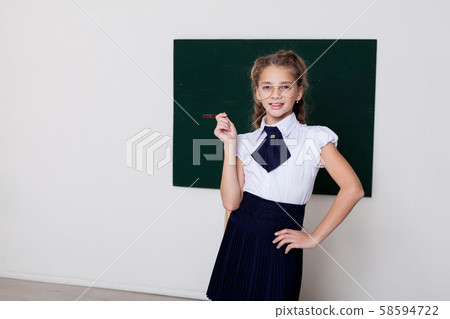 Beautiful schoolgirl girl at the board in class in class 58594722