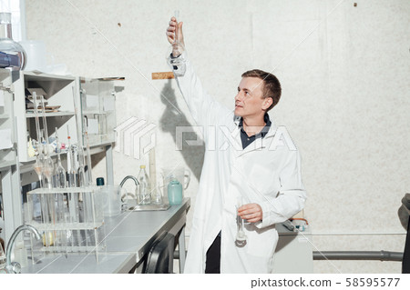 young scientist conducts chemical experiments in the laboratory 58595577