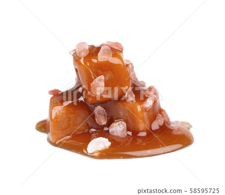 Salted caramel candies and sauce, isolated on white background. Delicious caramel. Salted caramel candies and sauce, isolated on white background. Delicious caramel. 58595725