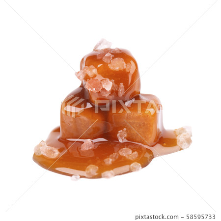 Salted caramel candies and sauce, isolated on white background. Delicious caramel. Salted caramel candies and sauce, isolated on white background. Delicious caramel. 58595733