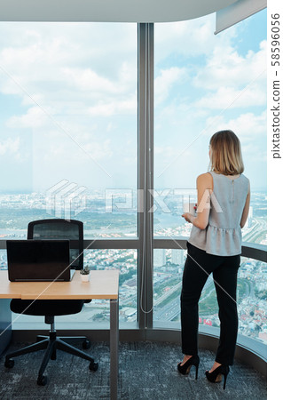 Ambitious businesswoman drinking morning coffee 58596056