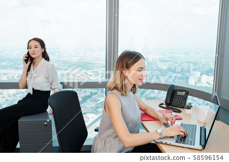 Businesswoman answering e-mails Businesswoman answering e-mails 58596154