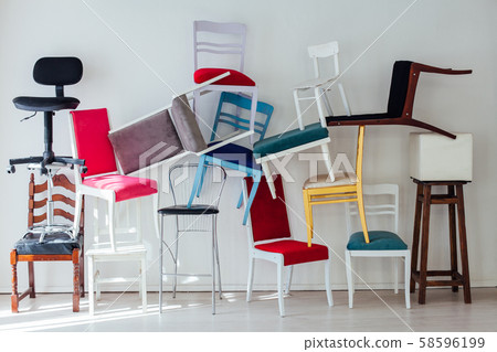 many different chairs stand in the white room many different chairs stand in the white room 58596199