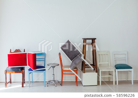 many multicolored chairs stand in the white room many multicolored chairs stand in the white room 58596226