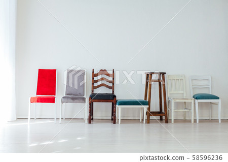many multicolored chairs stand in the white room many multicolored chairs stand in the white room 58596236
