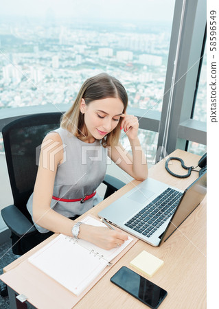 Smiling businesswoman planing day Smiling businesswoman planing day 58596549
