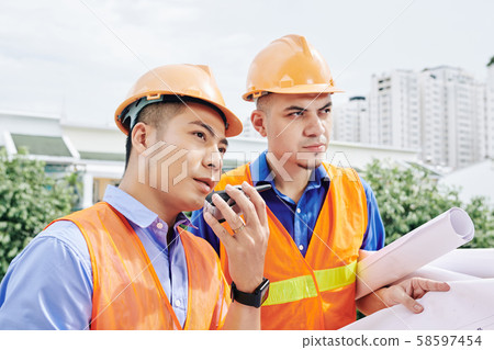 Contractor using walkie-talkie-talkie for communication Contractor using walkie-talkie-talkie for communication 58597454
