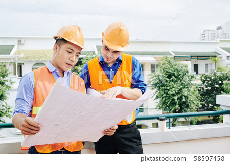 Engineer and contractor discussing blueprint Engineer and contractor discussing blueprint 58597458