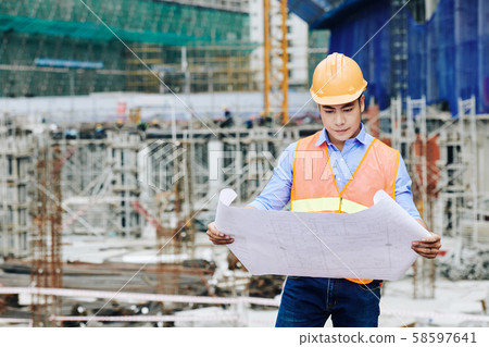 Civil engineer examining building plan 58597641