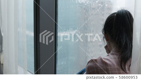 woman cry near by window woman cry near by window 58600953