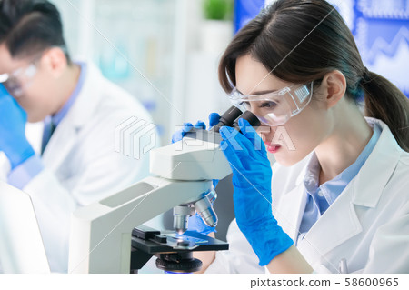Asian scientist use microscope Asian scientist use microscope 58600965