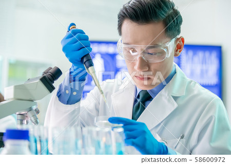 Asian scientist take petri dish Asian scientist take petri dish 58600972