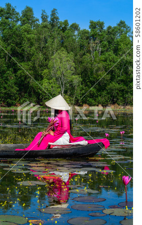 Asian woman on the wooden boat 58601202
