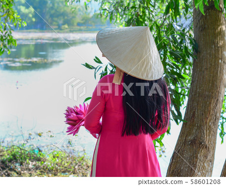 Asian woman with waterlily flowers 58601208