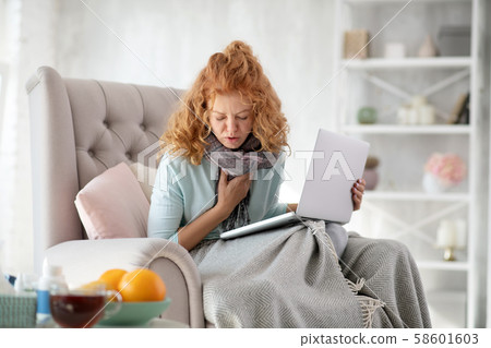 Young sick woman coughing after catching seasonal cold 58601603