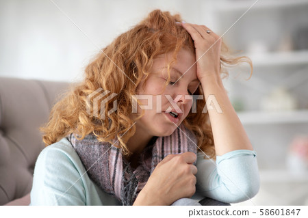Woman feeling terrible having high body temperature Woman feeling terrible having high body temperature 58601847