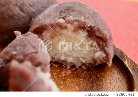 Handmade rice balls filled with bean paste, split in half Handmade rice balls filled with bean paste, split in half 58603481