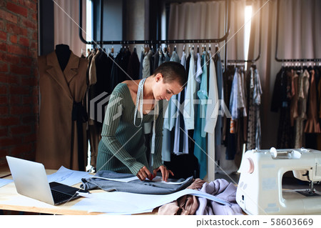 Caucasian fashion designer working in studio 58603669