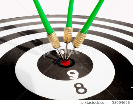 Target with three green dart focus on bull's eye, Setting challenging business goals And ready to achieve the goal with teamwork concept Target with three green dart focus on bull's eye, Setting challenging business goals And ready to achieve the goal with teamwork concept 58604666