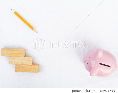 Pink piggy bank on white background with wooden block and yellow pencil, Drawing own way to saving money for future plan and retirement fund concept 58604755