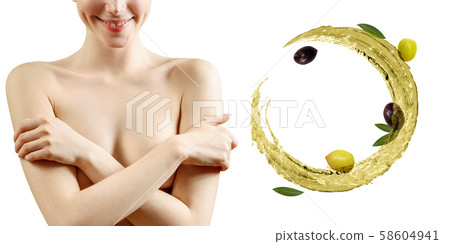 Young beautiful woman looks on splash of olive oil. Young beautiful woman looks on splash of olive oil. 58604941
