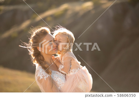 Portrait of a beautiful young mom holds her 58606350