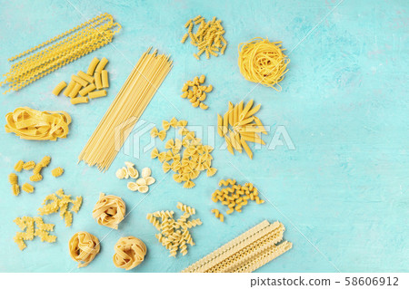 Italian pasta variety, flat lay banner, shot from the top on a blue background with a place for text 58606912