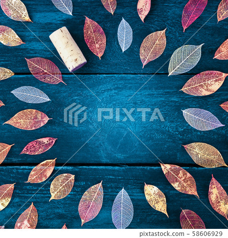 Autumn wine tasting invitation. Vibrant autumn leaves on a dark wooden background, a square flat lay Autumn wine tasting invitation. Vibrant autumn leaves on a dark wooden background, a square flat lay 58606929