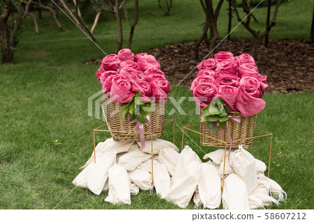 Warm pink blankets rolled up in the form of roses 58607212
