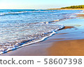 Amazing beach sunset with incredible foamy waves. 58607398