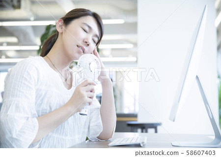 Women who use a handy fan Women who use a handy fan 58607403