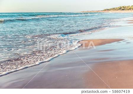 Amazing beach sunset with incredible foamy waves. Amazing beach sunset with incredible foamy waves. 58607419