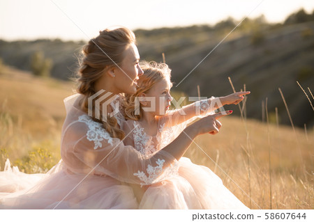 Young mother with a little daughter in pink Young mother with a little daughter in pink 58607644