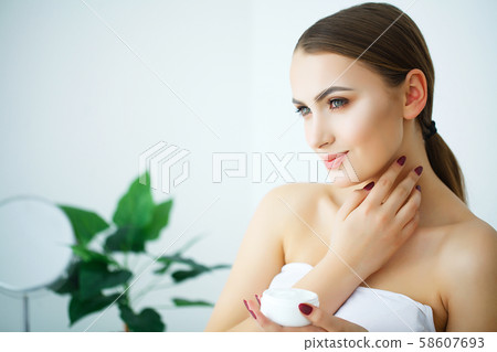 Beauty Face Care. Woman Applying Cream On Skin. 58607693