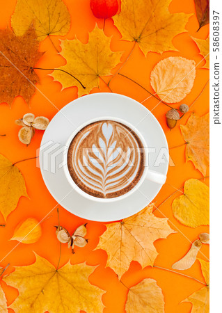 Coffee latte cup in dry autumn leaves wreath frame 58608397