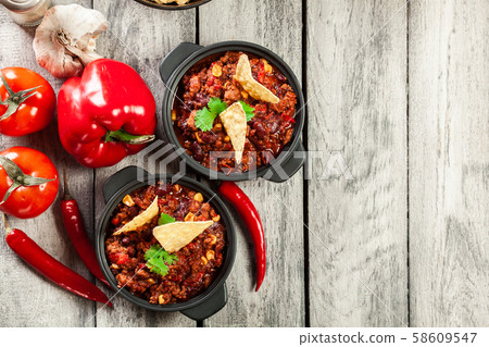 Bowls of hot chili con carne with ground beef, 58609547