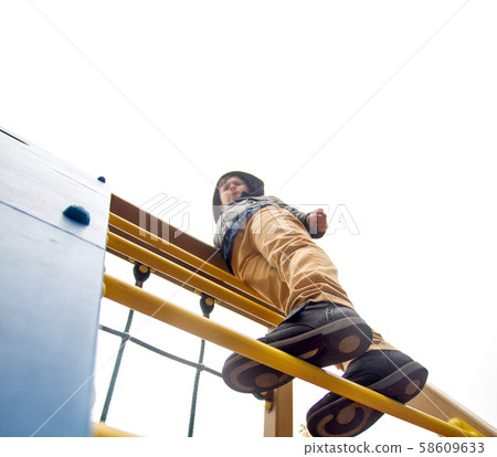 Boy climbs to the top 58609633