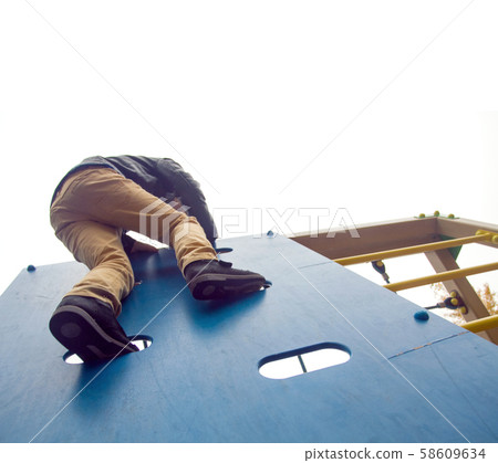 Boy climbs to the top 58609634