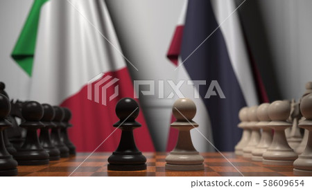 Flags of Italy and Thailand behind pawns on the chessboard. Chess game or political rivalry related 58609654