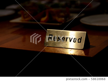 Reserved table sign in restaurant, silver reserved 58610068
