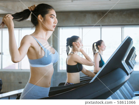 Woman running in a gym on a treadmill concept for Woman running in a gym on a treadmill concept for 58611066