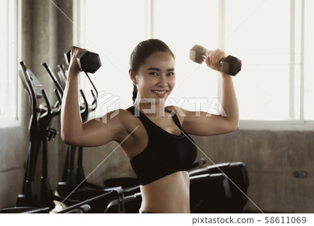 Sporty fit woman workout exercises with dumbbells. Sporty fit woman workout exercises with dumbbells. 58611069