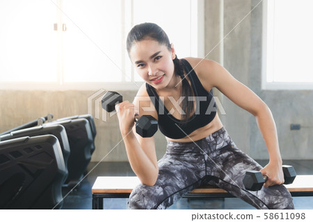 Sporty fit woman workout exercises with dumbbells. Sporty fit woman workout exercises with dumbbells. 58611098