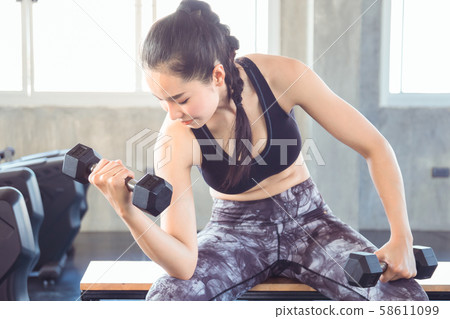 Sporty fit woman workout exercises with dumbbells. Sporty fit woman workout exercises with dumbbells. 58611099