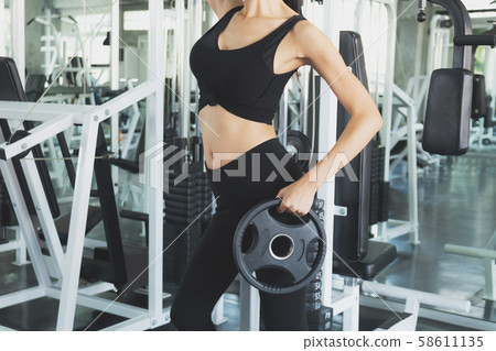 Fit woman doing exercise workout for arms with 58611135