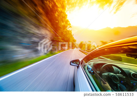 Car in motion blur driving in the Mountains Car in motion blur driving in the Mountains 58611533