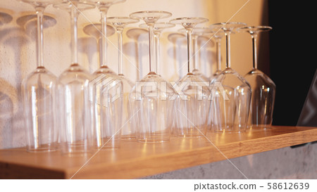 Lots of wine glasses on shelf 58612639