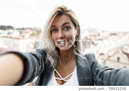 Surprised funny beautiful young woman with a smile Surprised funny beautiful young woman with a smile 58613238