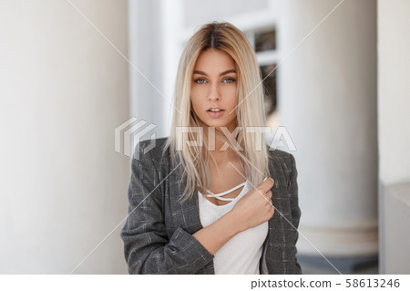 Young beautiful blond girl in vintage gray jacket Young beautiful blond girl in vintage gray jacket 58613246