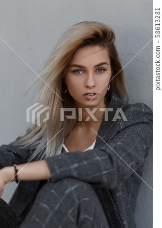Young blond girl in a fashionable vintage suit Young blond girl in a fashionable vintage suit 58613281